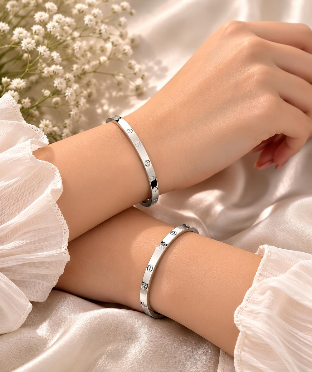 Love screw bangle bracelet on two wrists