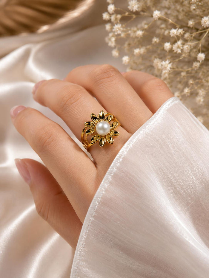 Gold flower pearl ring on hand