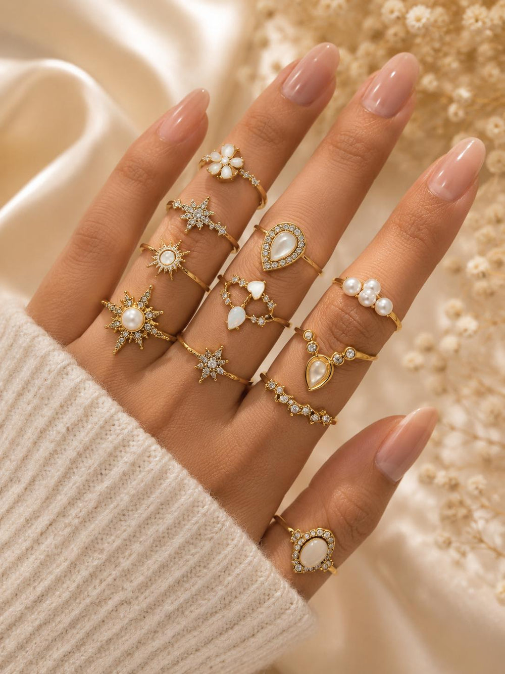 Gold pearl boho rings on model hand