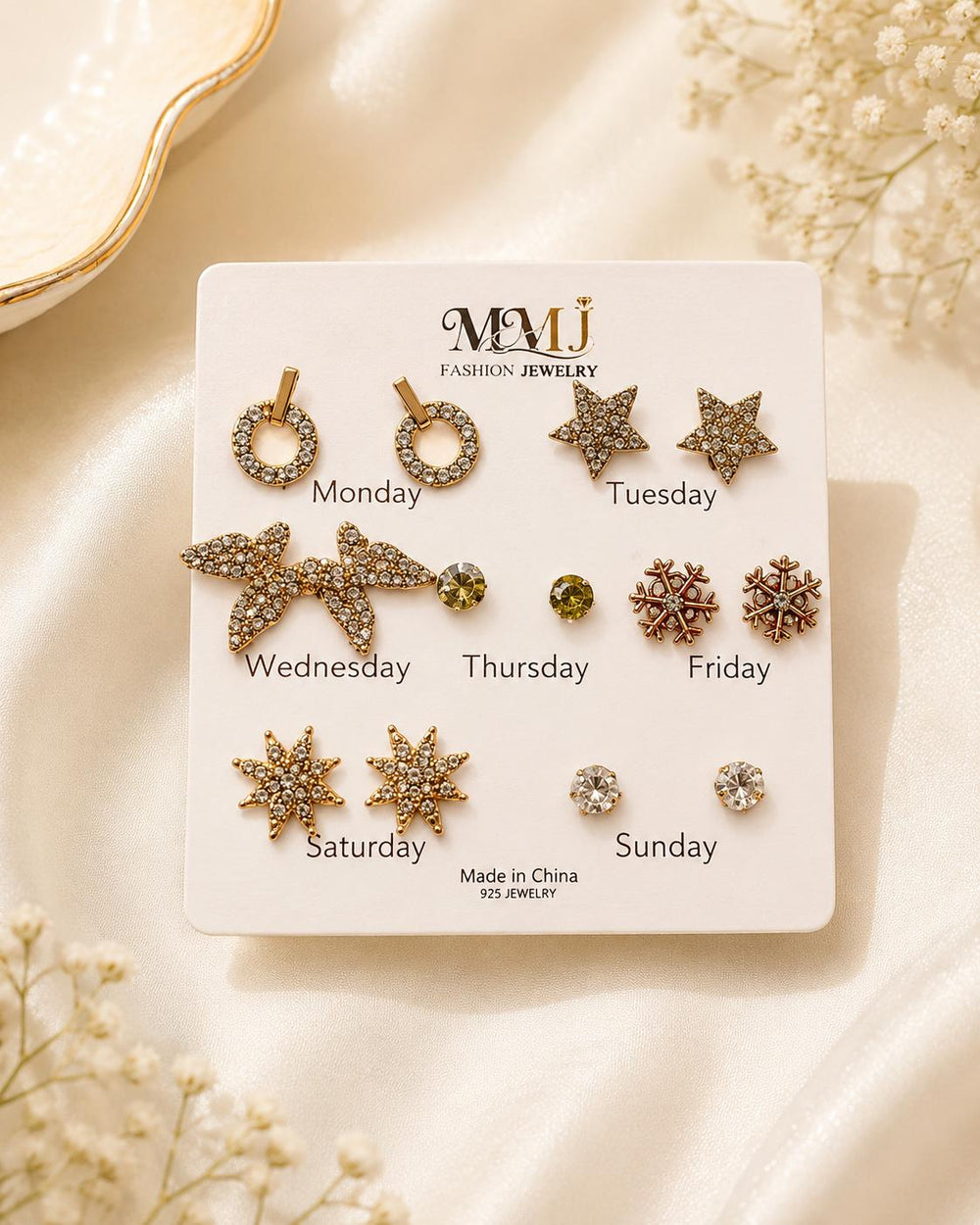 MMJ weekday earrings set on card