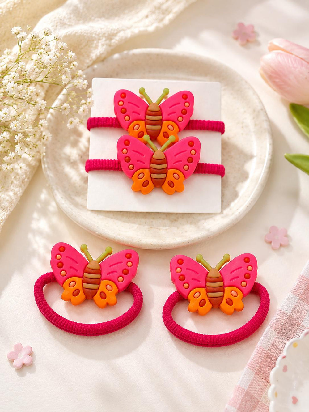 Butterfly hair ties pink and orange on card