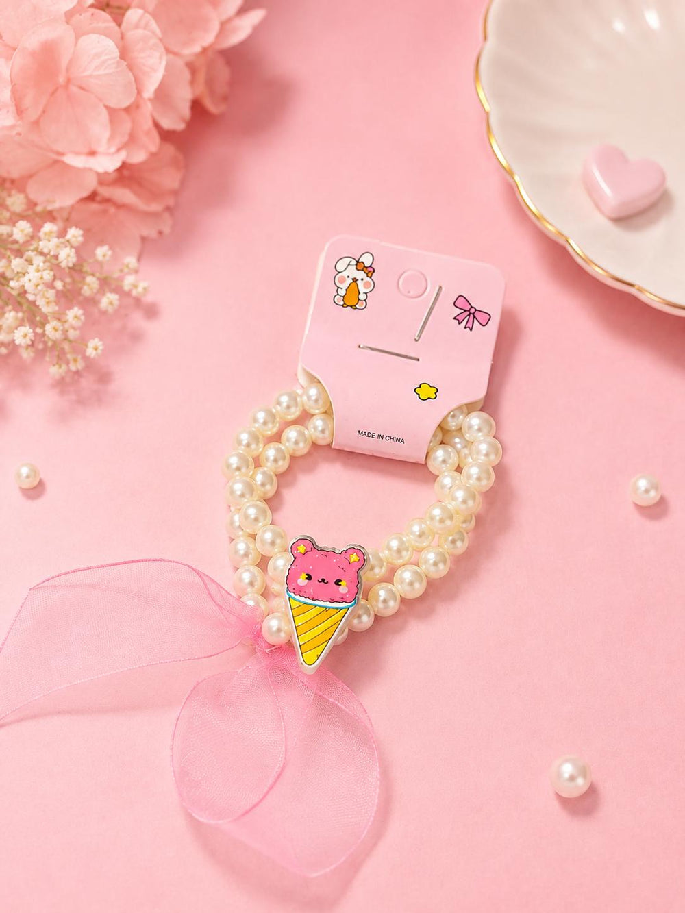 Pearl ice cream cone bracelet on pillow